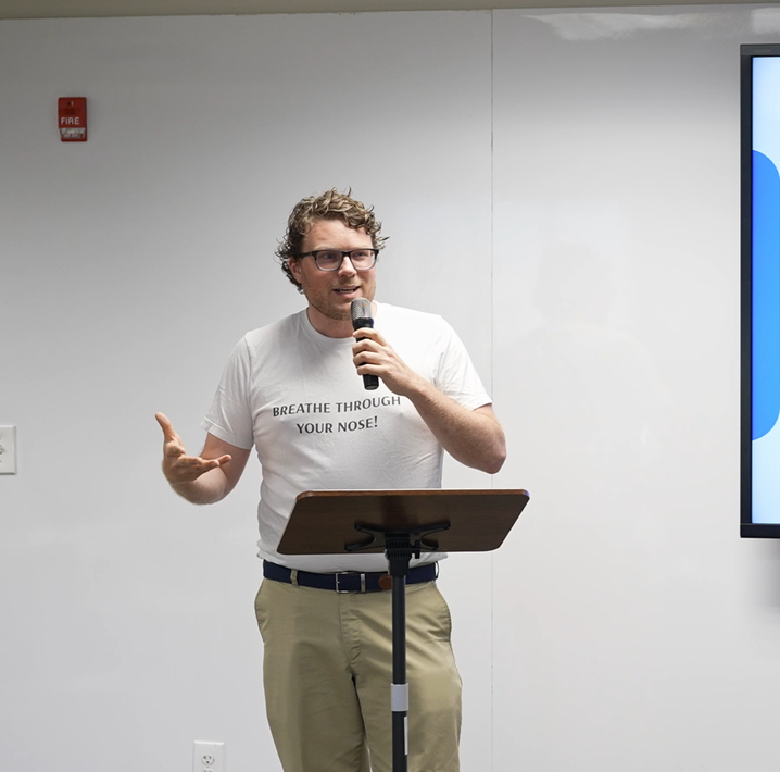 Chase Barber presenting to an audience on stage